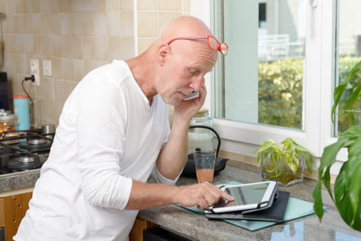 middle-aged man with a mobile phone and tablet