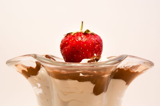Glass cup with mixed vanilla and chocolate with strawberry