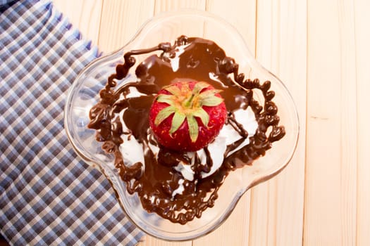 Glass cup with mixed vanilla and chocolate with strawberry
