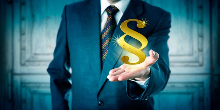 Male corporate attorney offering a golden section sign hovering above his open palm of hand. Business concept for justice system, legal representation, court proceedings, compliance and consultancy.