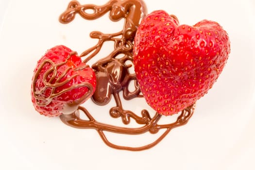Plate with poured chocolate over strawberry