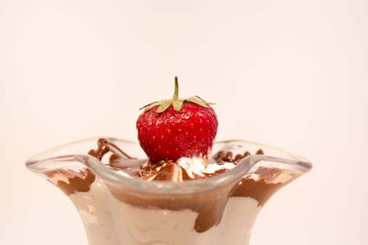 Glass cup with mixed vanilla and chocolate with strawberry