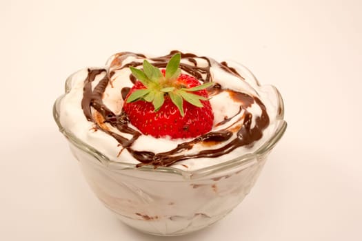 Strawberry on tof of creamy desert with vanilla and chocolate