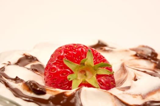 Strawberry on tof of creamy desert with vanilla and chocolate
