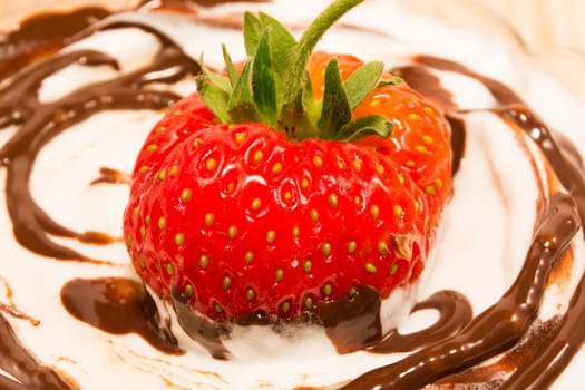 Strawberry on tof of creamy desert with vanilla and chocolate