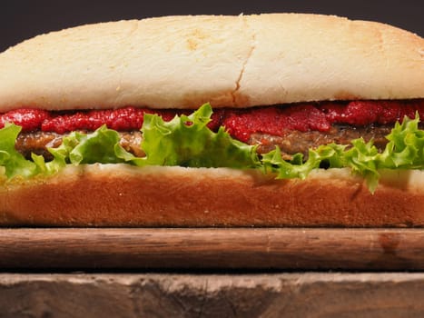 Closeup shot of a delicious burger on a rustic wooden table