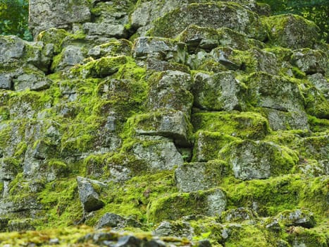 Old rocks with fresh green moss, natural texture background with space for text or image