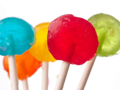 Colorful sweet lollies on a white background, selective focus on foreground