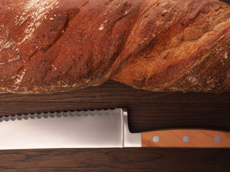 Closeup of an organic baguette bread on a wooden table