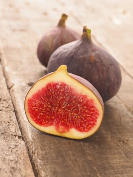 Fresh organic figs on a rustic wooden table in a kitchen