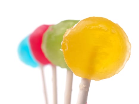 Four colorful lollypop in a row on a white background