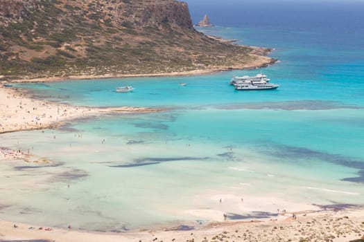 Breathtaking panorama of Balos beach and lagoon and Gramvousa island on Crete, Greece. Tourist boats mooring in lagoon.