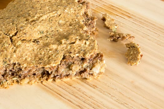 Part of just baked, fresh, domestic unleavened barley bread on the wooden plate