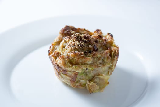 Zucchini muffins in white plate isolated on white background
