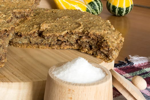 Just baked, fresh, domestic unleavened barley bread on the wooden plate, cutted in half