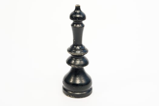 Old wooden chess piece black king isolated on white background