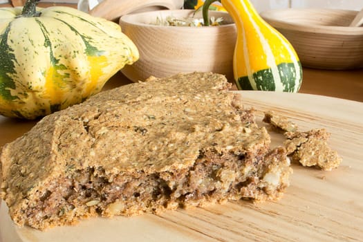 Part of just baked, fresh, domestic unleavened barley bread on the wooden plate