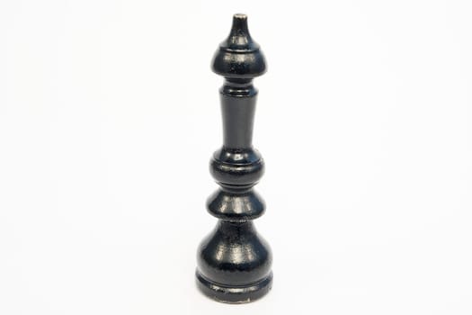 Old wooden chess piece black King isolated on white background