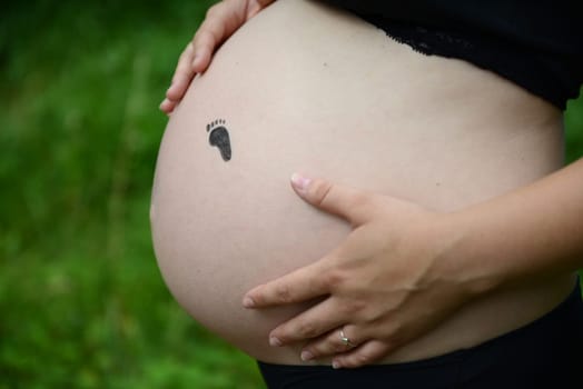 Baby belly with painted small feet