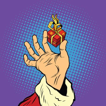 Hand of Santa Claus and a small gift, pop art retro vector illustration. Holidays New year and Christmas