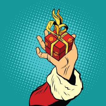 Hand of Santa Claus with gift, pop art retro vector illustration. Holiday New year and Christmas