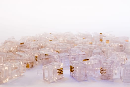 Group of RJ-45 connectors on white background, Connectors are translucent and collored with blue light