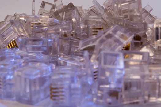 Group of RJ-45 connectors on white background, Connectors are translucent and collored with blue light