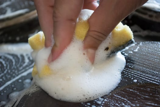 Close up of woman cleaning cooker at home kitchen