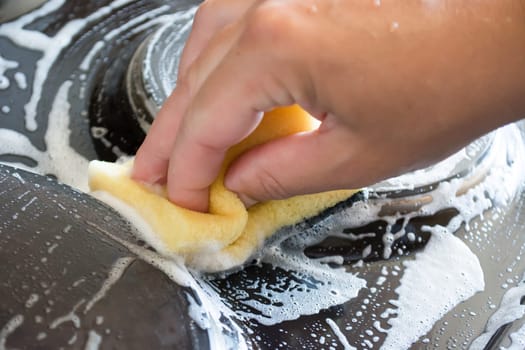 Close up of woman cleaning cooker at home kitchen