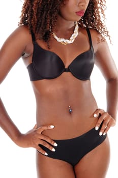A closeup image of the torso of a young African American woman .standing in panties and bra, isolated for white background..