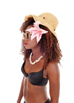 A lovely young African American woman in a black bra and straw hat.standing in profile isolated for white background..