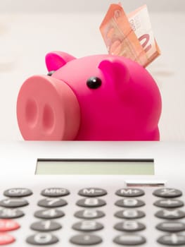 piggy bank with money and calculator