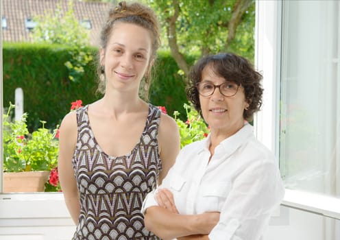 portrait of a mother and daughter near the window