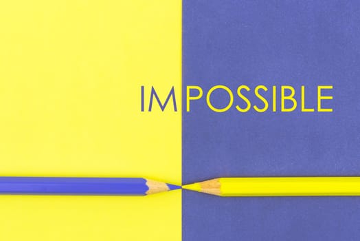 Impposible contrast concept with Yellow and Violet coloured pencils and paper.