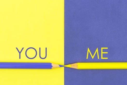 You versus Me contrast concept . Yellow and Violet coloured pencils and paper.