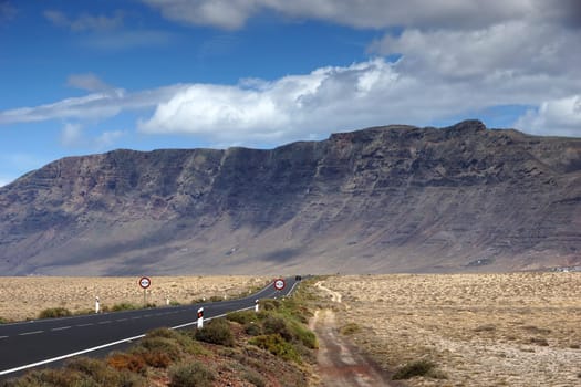 The up to 600m high rock walls of the Risco de Famara behind the desert El Jable,Lanzarote