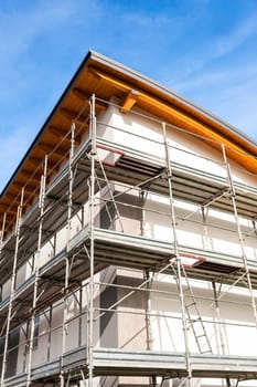 House under renovation with the scaffolding for bricklayers