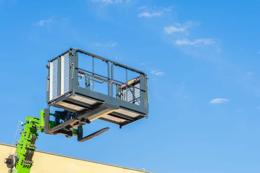 Forklift telescopic boom with buckets and aerial working platform.