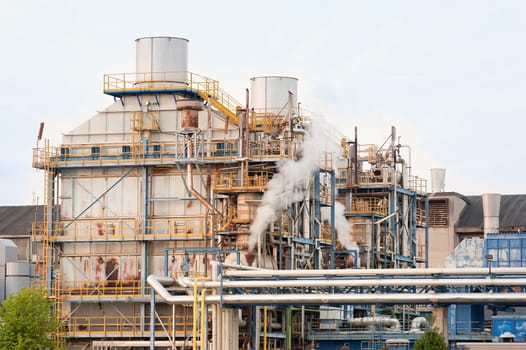 Chemical plant of a factory. Smokestacks ,pipes and tank.