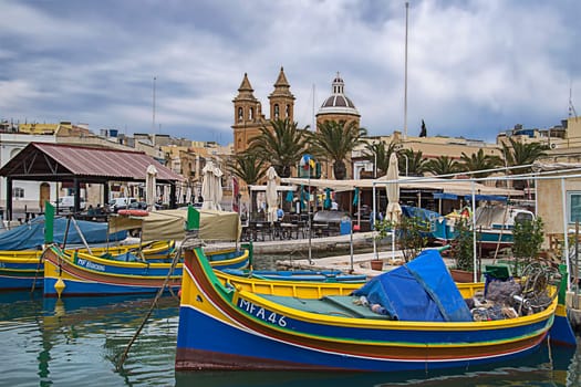 Marsaxxlokk with fishing boats and cathedral