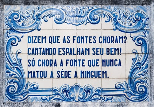 OVAR, PORTUGAL - SEPTEMBER 3, 2016: Panel of traditional Portuguese tiles hand-painted blue and white, with written quoted verses from a poem about water.