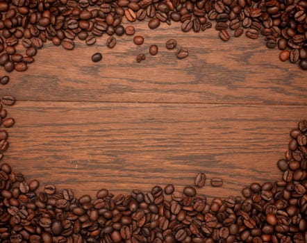 Espresso beans on an old oak texture with space for text
