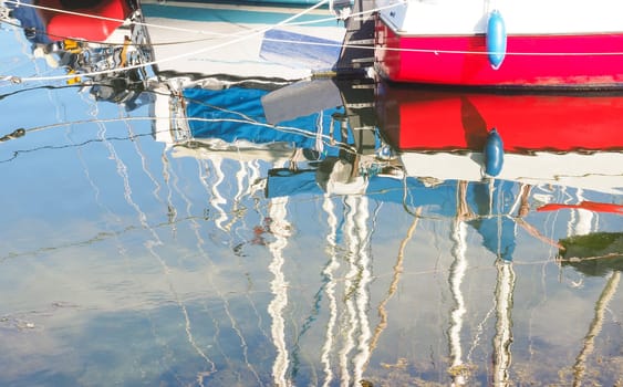Reflections of colorful boats in a marina