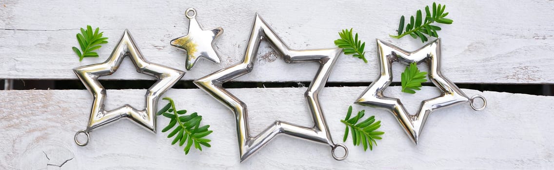 Christmas stars natural decoration on white wood background