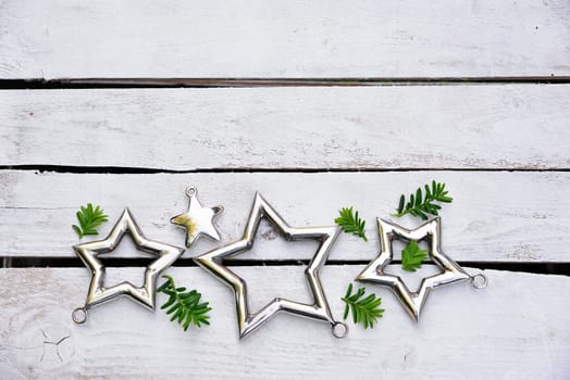 Christmas stars natural decoration on white wood background