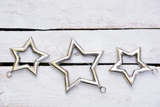 Christmas stars natural decoration on white wood background