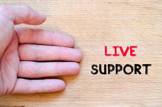 Live support text concept with human hand over wooden background
