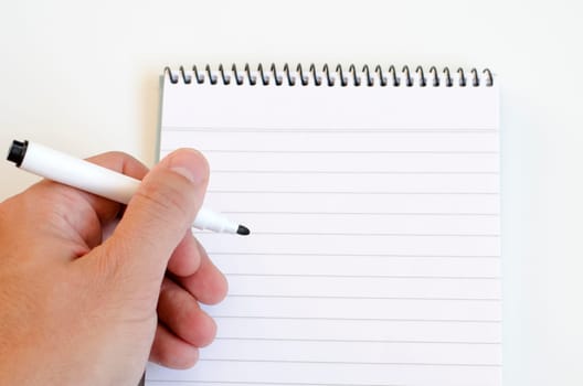 Human hand and notepad over white background