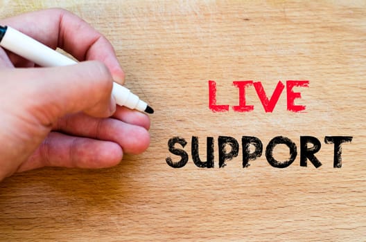 Live support text concept with human hand over wooden background