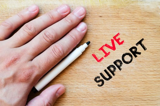 Live support text concept with human hand over wooden background